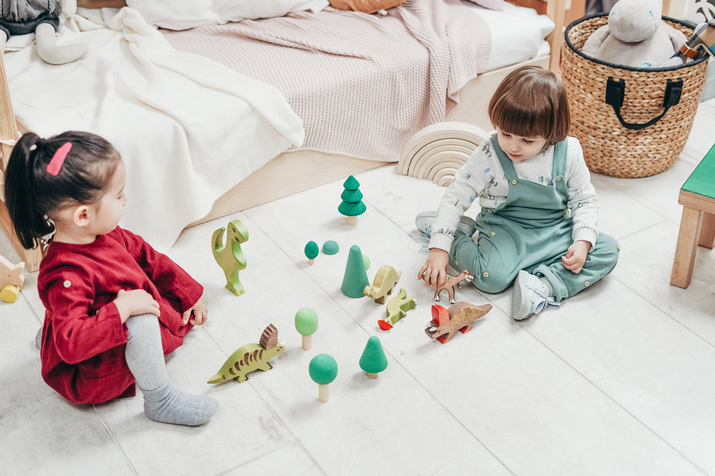 toddlers playing in bed